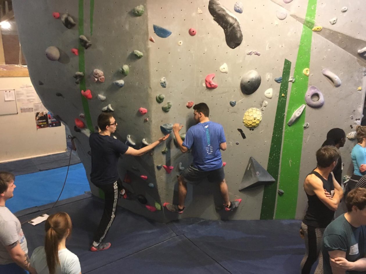 Two men climbing a couples climb