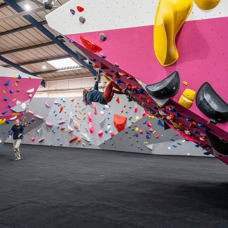 A girl on a bouldering wall at The Climbing Hangar Edinburgh