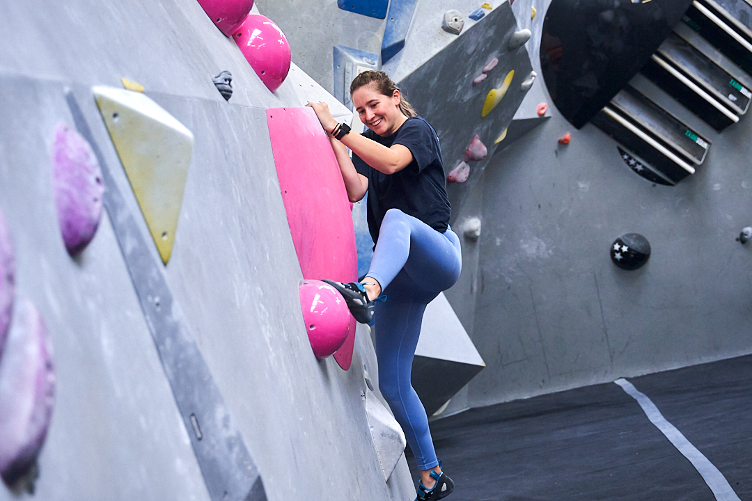 A girl bouldering at The Climbing Hangar