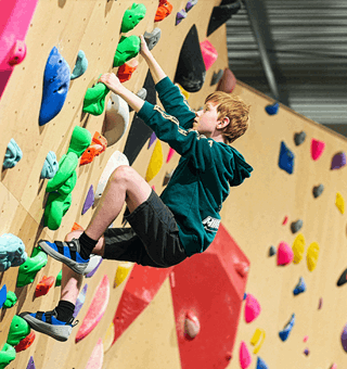A child bouldering at The Climbing Hangar