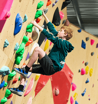 A child bouldering at The Climbing Hangar