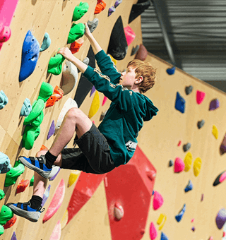 A child bouldering at The Climbing Hangar