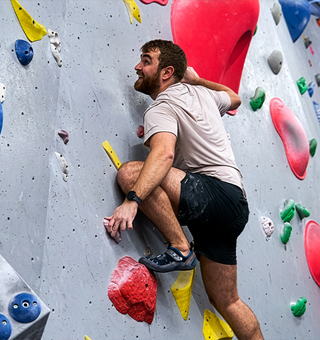 A man bouldering at The Climbing Hangar