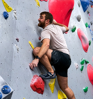A man bouldering at The Climbing Hangar