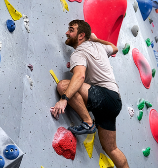 A man bouldering at The Climbing Hangar