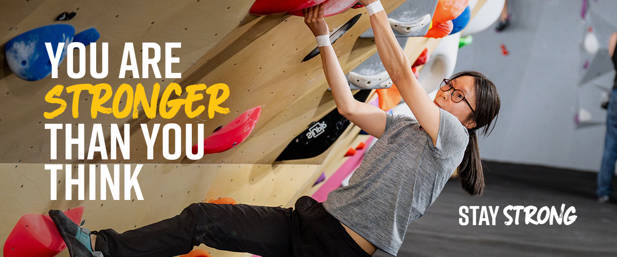 A woman bouldering at The Climbing Hangar