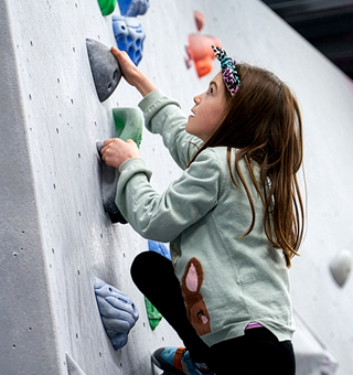 A kid bouldering at The Climbing Hangar Edinburgh